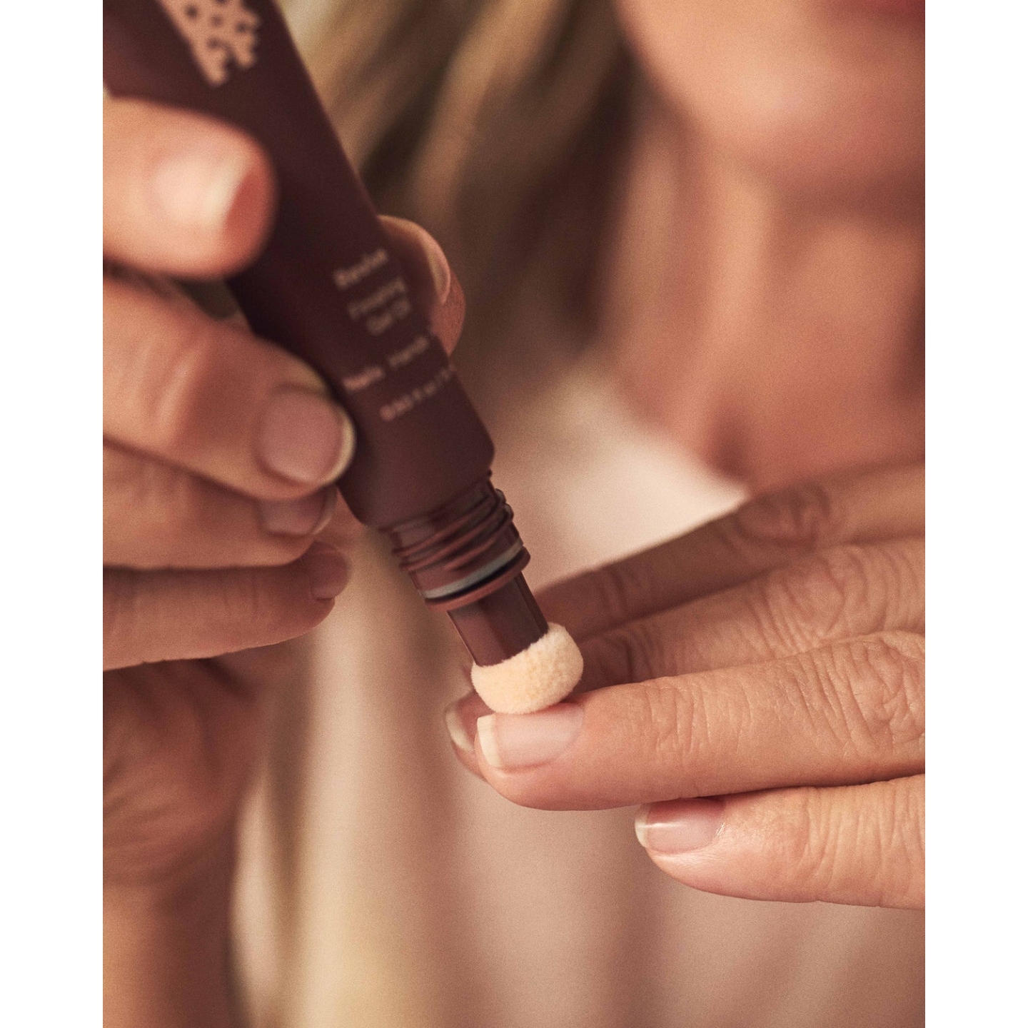 Close-up application of Buff Beauty Revive Finishing Gel Oil using its soft sponge applicator directly onto clean cuticles and natural nails.