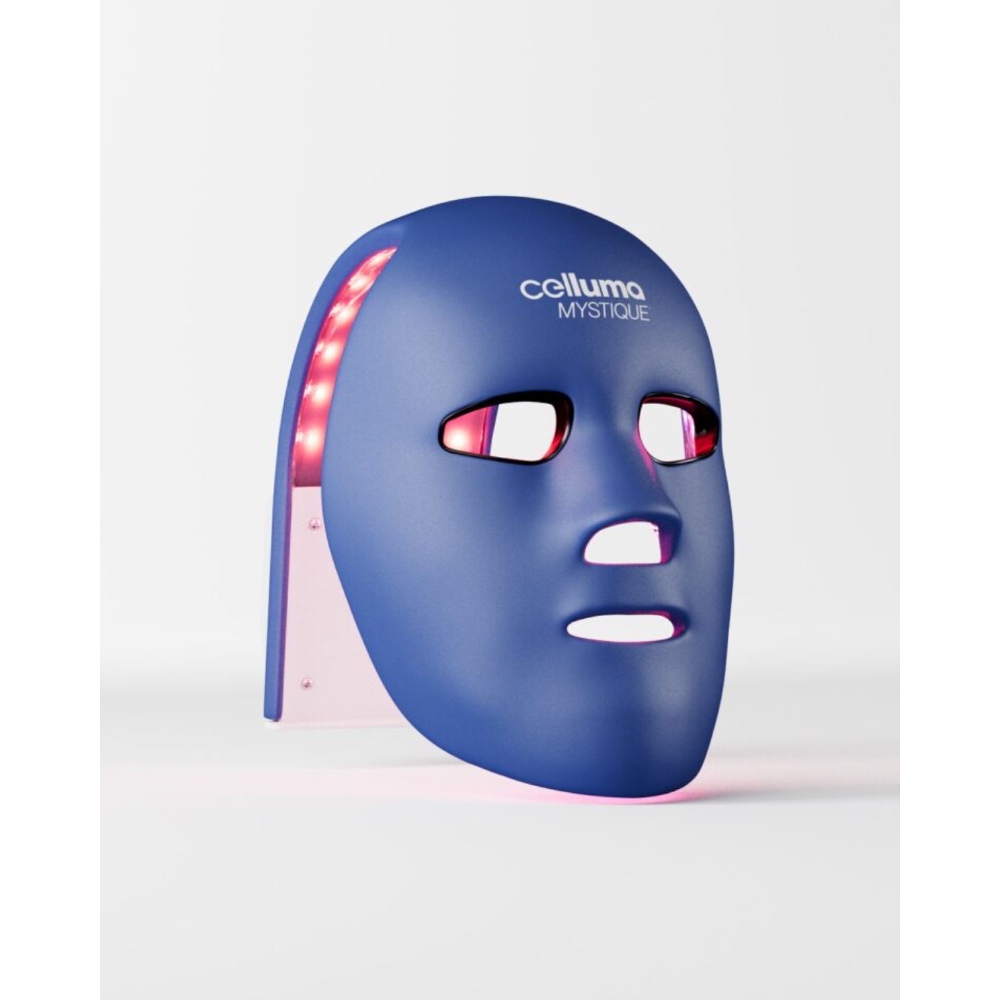 A dark blue Celluma Mystique LED face mask illuminating with red light against a white background, featured on Beauty News Daily.