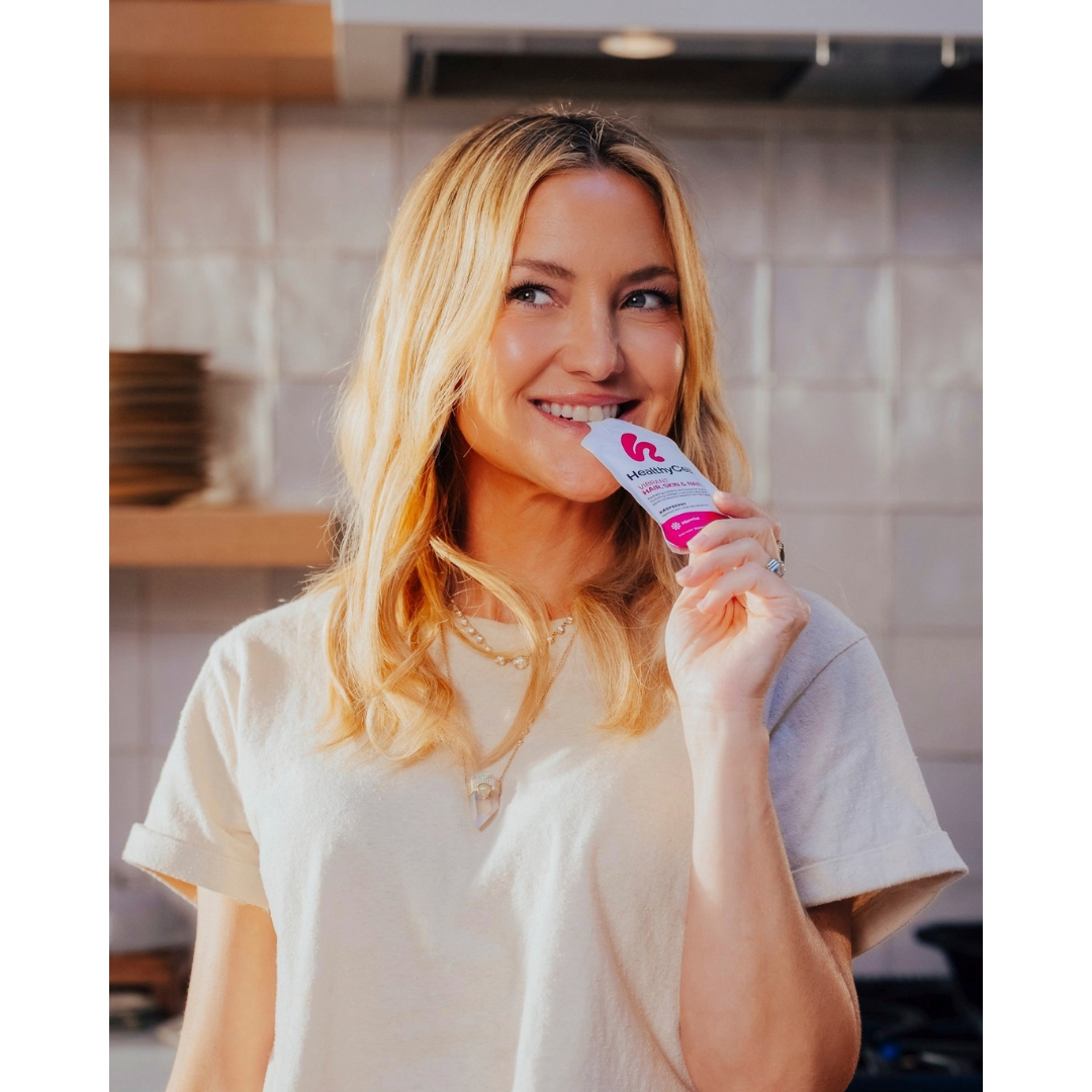 Kate Hudson sipping from a HealthyCell Hair, Skin & Nails sachet.