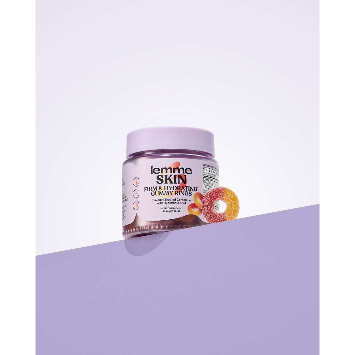 A jar of Lemme Skin Firming & Hydrating Gummy Rings with a single sugar-dusted gummy propped next to it against a pastel purple split background, featured in a daily beauty news roundup on Beauty News Daily.