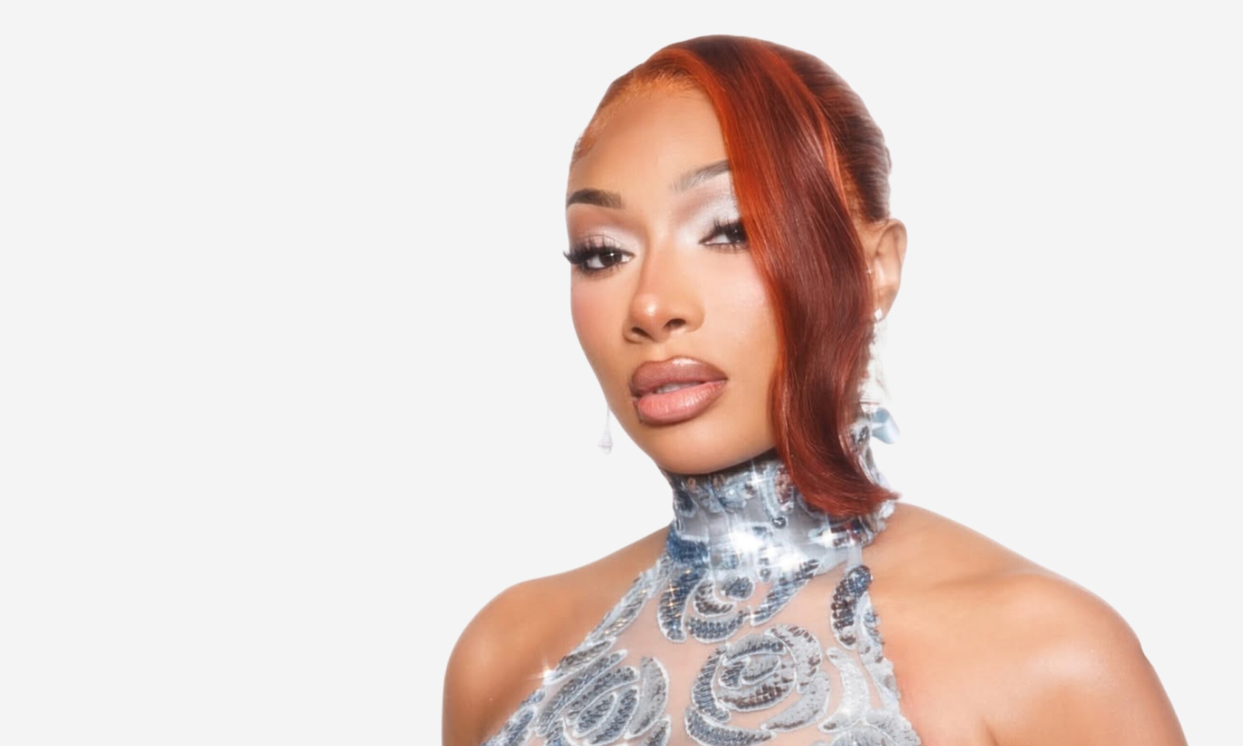 Megan Thee Stallion with reddish-brown hair and a silver high-neck dress in a photo from her Instagram, featured in the coverage of her first fragrance launch on Beauty News Daily.