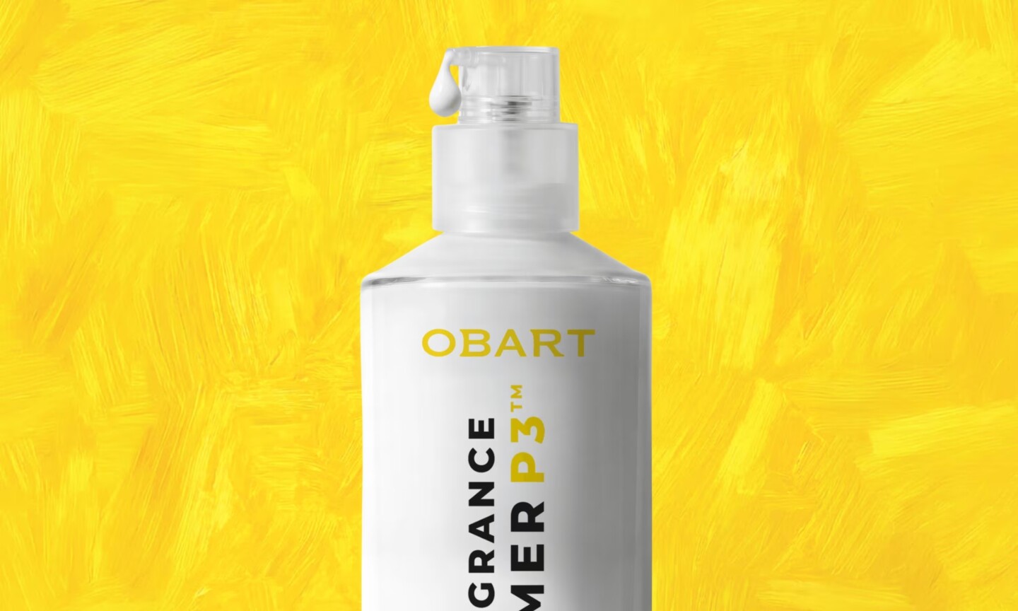 A white pump bottle of Obart Fragrance Primer P3 with yellow and black text, set against a textured bright yellow background.