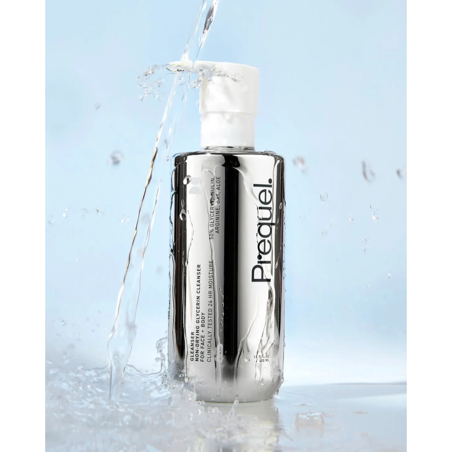 Water splashing over the metallic silver bottle of Prequel Gleanser Non-Drying Glycerin Cleanser, featured on Beauty News Daily.