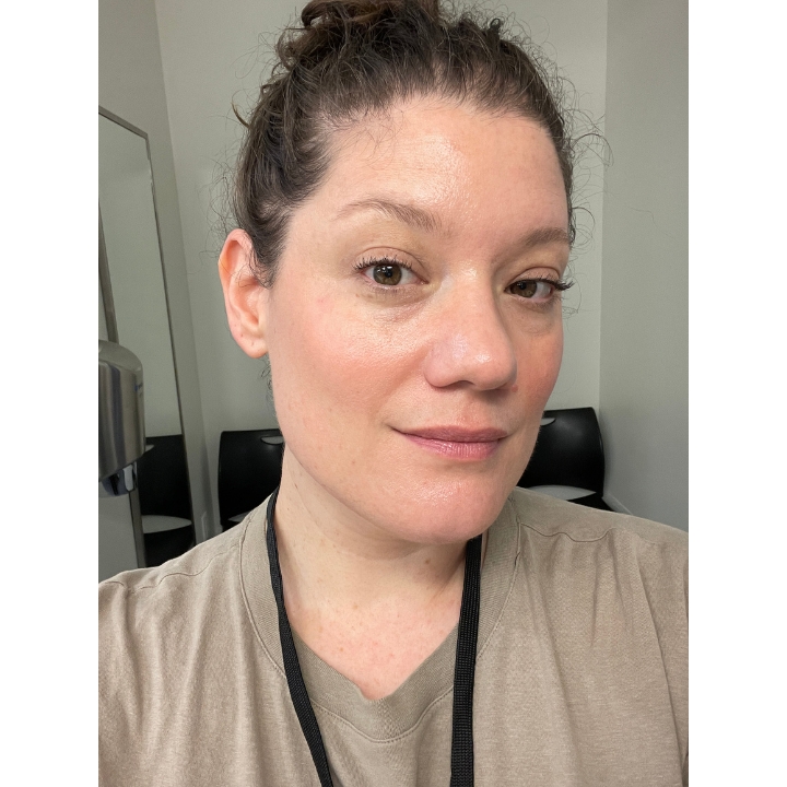 Selfie of a woman testing Tower 28 Swipe Serum Foundation indoors after 2 hours of wear showing a natural glow.