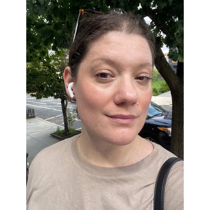 Selfie of a woman wearing Tower 28 Swipe Serum Foundation outdoors after 4 hours of wear showing a radiant finish.